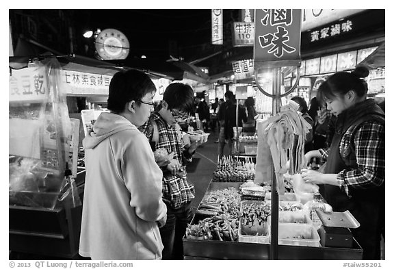 Customer buying foods at Shilin Night Market. Taipei, Taiwan (black and white)