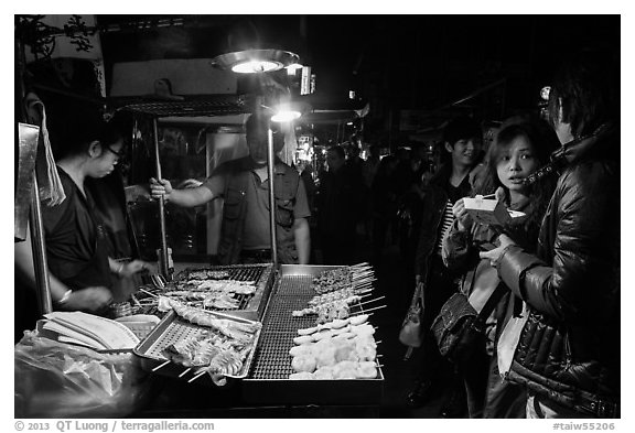 Sampling snacks at Shilin Night Market. Taipei, Taiwan (black and white)
