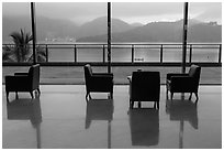 Chairs in hotel lobby with view of lake. Sun Moon Lake, Taiwan (black and white)