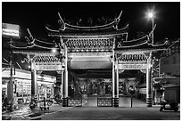 Temple gate and convenience store at night, Matzu Temple. Lukang, Taiwan (black and white)
