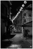 Red paper lanterns glowing in  Nine-turns lane at night. Lukang, Taiwan ( black and white)