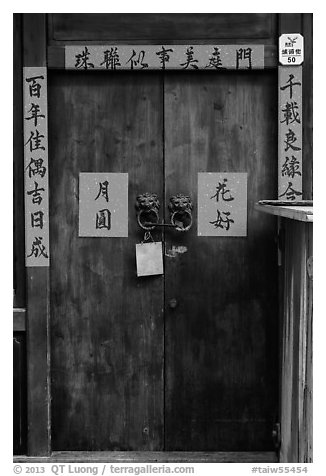 Wooden door traditional lock and chinese inscription on red paper. Lukang, Taiwan (black and white)