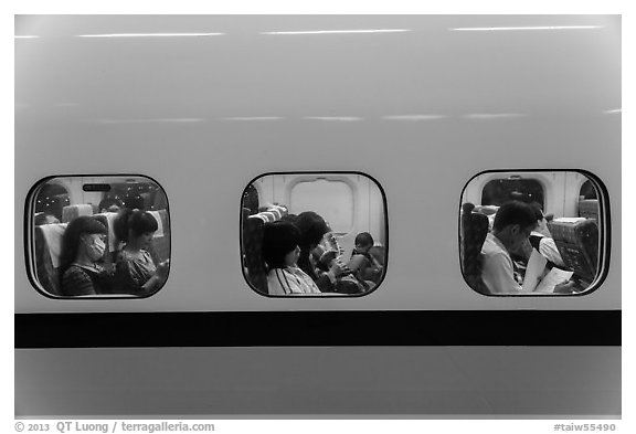 High speed rail car passengers seen through windows. Taiwan (black and white)
