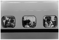 High speed rail car passengers seen through windows. Taiwan (black and white)