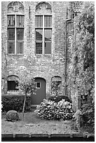 Brick house with small garden by the canal. Bruges, Belgium (black and white)