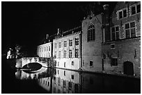 Bridge and houses reflected in canal at night. Bruges, Belgium ( black and white)