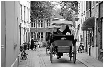 Horse carriage in a narrow street. Bruges, Belgium (black and white)
