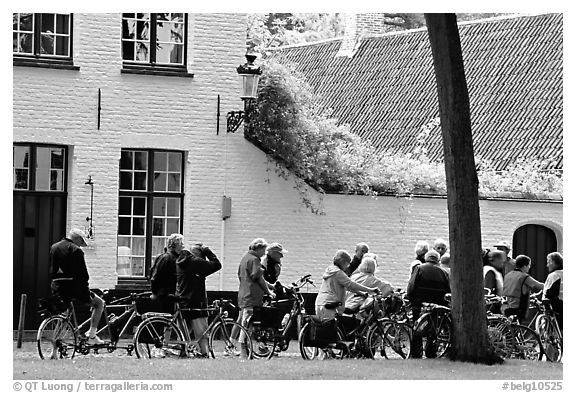 Bicylists in Courtyard of the Begijnhof. Bruges, Belgium