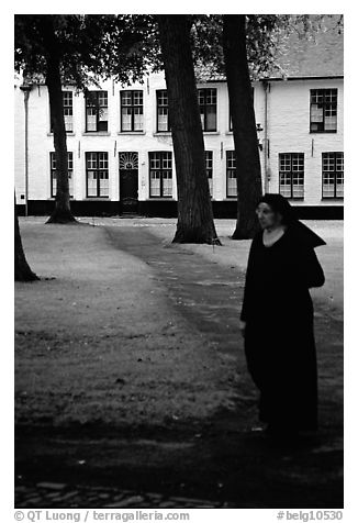 Benedictine nun in the Begijnhof. Bruges, Belgium (black and white)