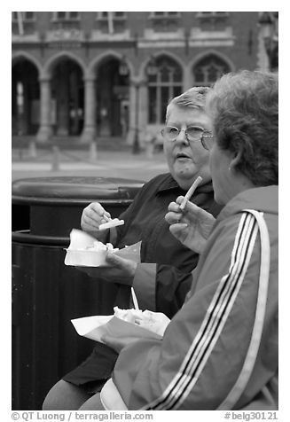 Elderly women eating fries. Bruges, Belgium