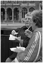Elderly women eating fries. Bruges, Belgium (black and white)