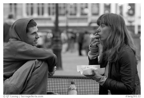 Young woman eating fries, Markt. Bruges, Belgium
