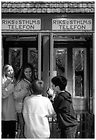 Swedish kids in a phone booth. Stockholm, Sweden (black and white)