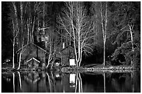 Wooden house reflected in a lake at sunset. Central Sweden ( black and white)
