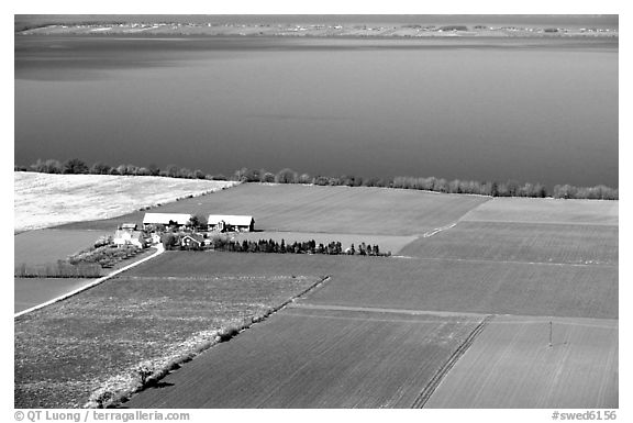 Fields bordering lake Vattern near Granna. Gotaland, Sweden (black and white)
