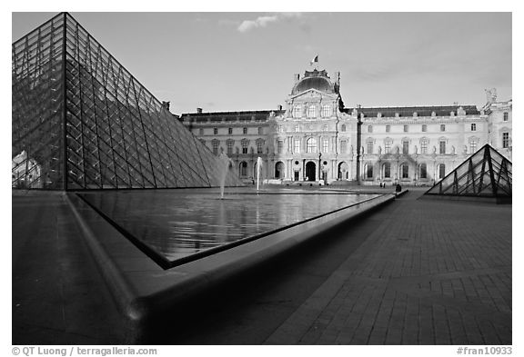 Pyramid, basins, and Sully Wing  in the Louvre, sunset. Paris, France (black and white)