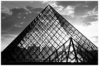 Sunset and clouds seen through Pyramid, the Louvre. Paris, France (black and white)