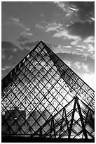 Louvre pyramid transparent at sunset. Paris, France (black and white)