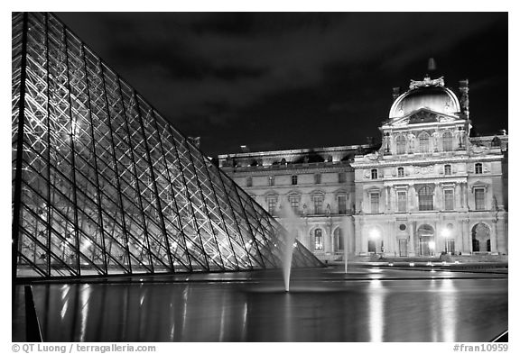 Pyramid, basin, and Louvre at night. Paris, France (black and white)