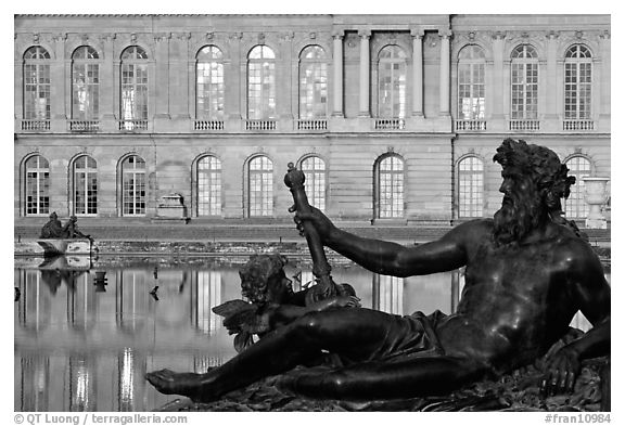 Statue, basin, and facade, late afternoon, Versailles Palace. France (black and white)