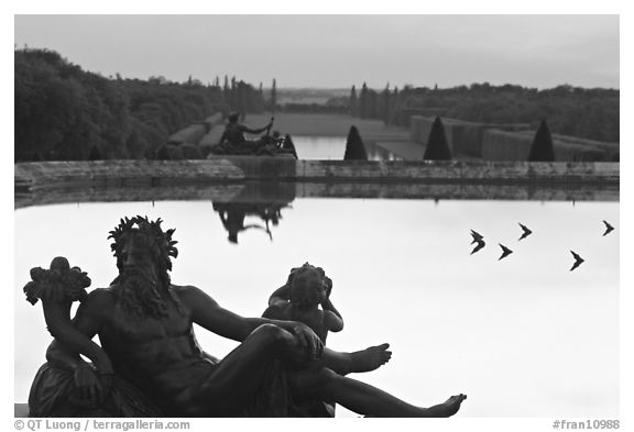 Sculptures, basin, and gardens at dusk, Palais de Versailles. France