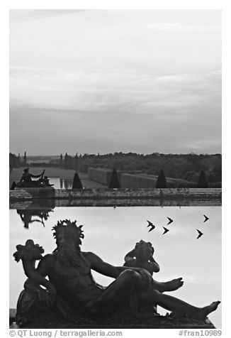 Sculptures, basin, and gardens at dusk, Versailles Palace. France (black and white)