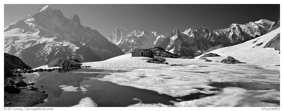 High mountain landscape with partly frozen lake and Mont-Blanc Range. France (black and white)