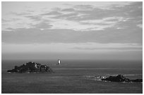 Islets and lighthouse on the coast. Brittany, France ( black and white)