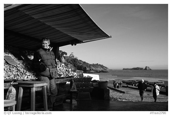 Oyster stand and vendor in Cancale. Cancale oysters are reknown in France. Brittany, France