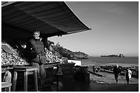 Oyster stand and vendor in Cancale. Cancale oysters are reknown in France. Brittany, France ( black and white)