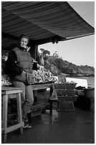 Oyster stand and vendor in Cancale. Brittany, France ( black and white)