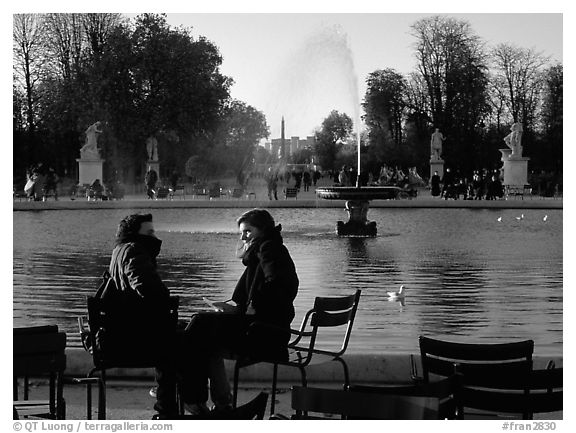 Couple sitting by basin in Tuileries Gardens. Paris, France (black and white)