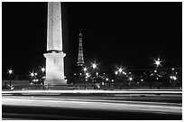 Car lights,  obelisk, and Eiffel Tower at night. Paris, France (black and white)