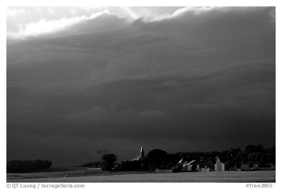 Stormy skies and village. France (black and white)