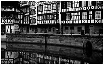 Half-timbered houses reflected in canal. Strasbourg, Alsace, France ( black and white)
