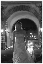 Woman in bridal gown in front of the Louvre by night. Paris, France ( black and white)