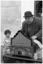 Barrel organ player and kid. Quartier Latin, Paris, France ( black and white)