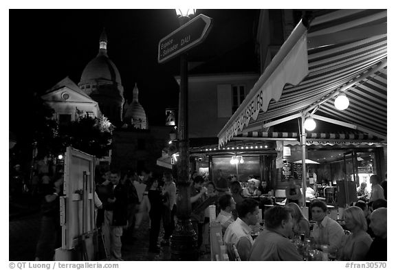 Outdoor dining at night on the Place du Tertre, Montmartre. Paris, France
