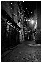 Lonely street by night with Tabac sign and Christmas lights. Carcassonne, France (black and white)