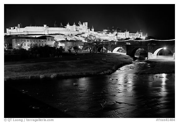 Fortified city and Pont Vieux crossing the Aude River by night. Carcassonne, France (black and white)