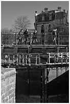 Pedestrians walking on brige above Canal du Midi. Carcassonne, France (black and white)