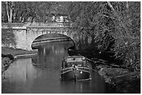 Tranquil scene with barge, bridge, and trees, Canal du Midi. Carcassonne, France (black and white)