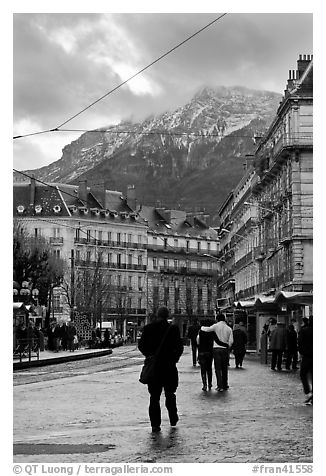 Downtown street and snowy mountains of the Belledone Range. Grenoble, France
