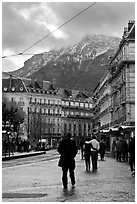 Downtown street and snowy mountains of the Belledone Range. Grenoble, France ( black and white)