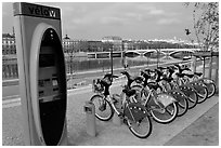 Bicycles for rent with automated kiosk checkout. Lyon, France ( black and white)