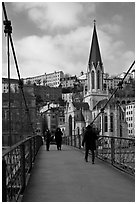 Walking across the passerelle Saint-Georges. Lyon, France (black and white)