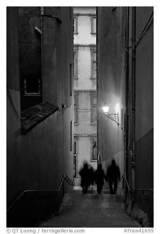 Silhouettes in staircase on Fourviere Hill at dusk. Lyon, France