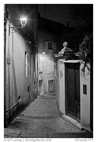 Narrow cobblestone street and street light. Avignon, Provence, France (black and white)