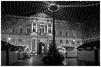 Christmas fair and City hall at night. Avignon, Provence, France ( black and white)