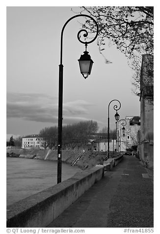 Walkway on the banks of the Rhone River at dusk. Arles, Provence, France